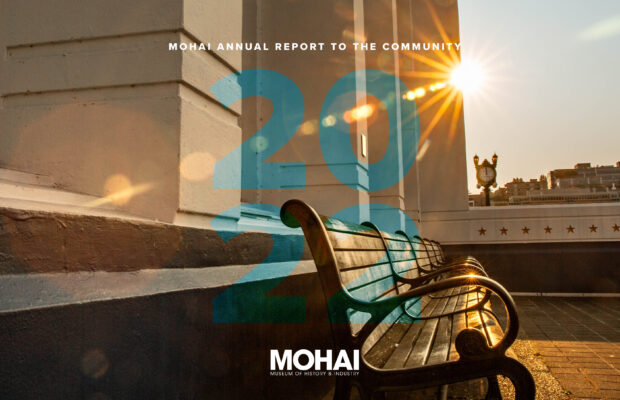 MOHAI 2022 Annual Report cover shows a benches outside the museum with the sun shining in the background.