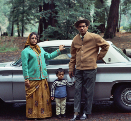 An Indian American family poses in front of their car in the 1960s.