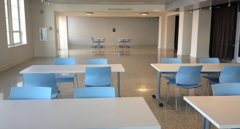 The Microsoft Lakefront Pavilion at MOHAI shown with white tables and blue chairs.