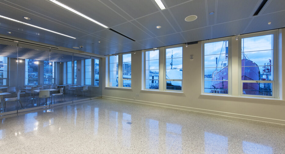 The Microsoft Lakefront Pavilion at MOHAI shown empty with boats seen through the windows.