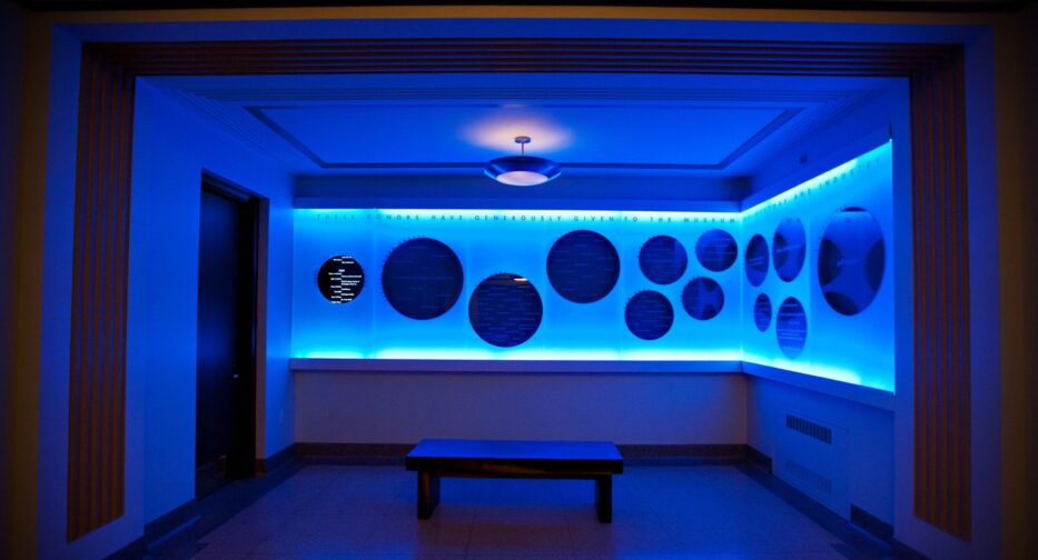 Donor wall at MOHAI with heavy blue lighting.