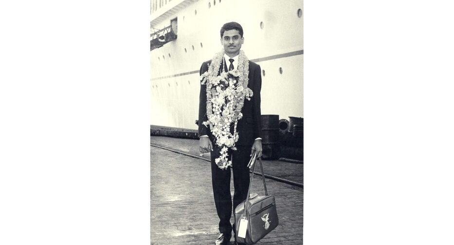 Wearing garlands presented by family members, Hemendra Momaya prepares to depart for the United States in 1965.