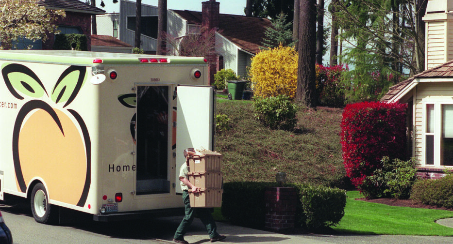 Brian Whetzel, driver for HomeGrocer.com, delivers groceries from his delivery truck to Cheryl Sanders in Kirkland.
