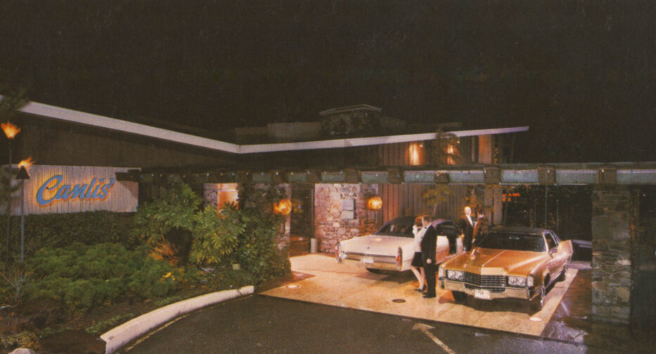 Two cars parked at Canlis, a fine dining restaurant overlooking Lake Union, in the 1970s.