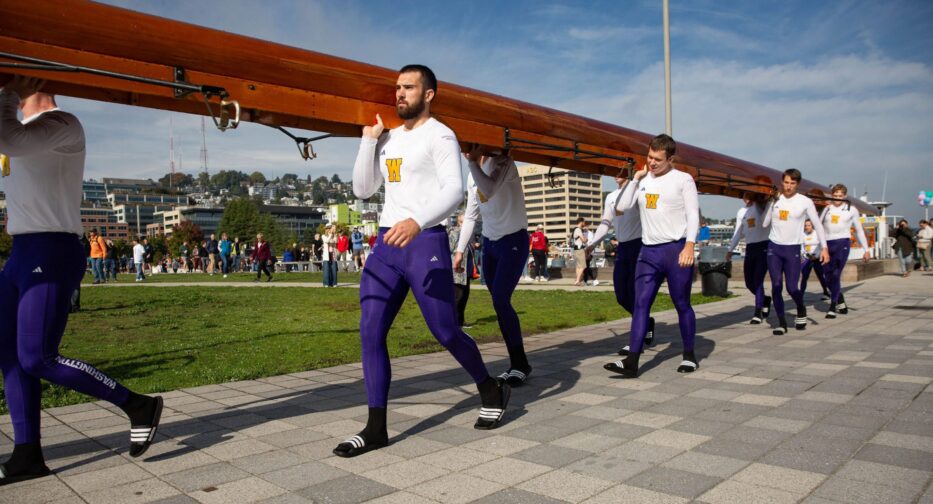 The University of Washington Men's Crew Team carrying the Husky Challenger through South Lake Union Park in downtown Seattle.
