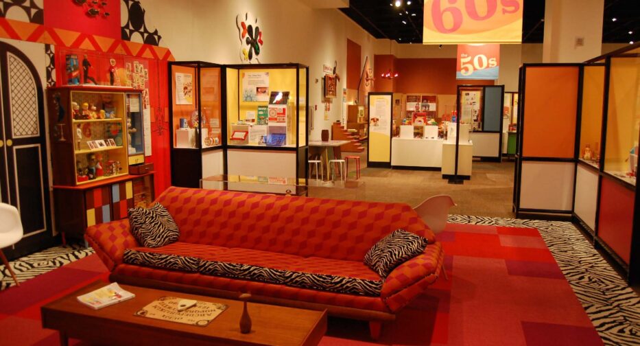 A mocked up living room from the 1960s with a Ouija board on display.