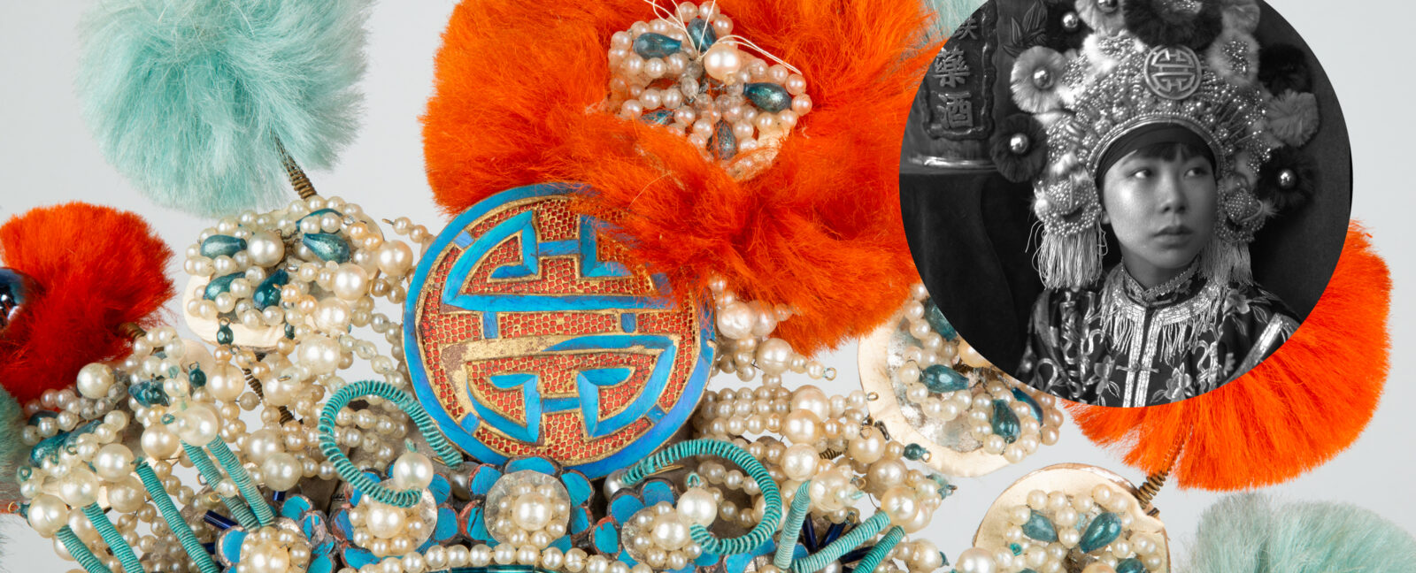 Person with elaborate headpiece on looking up and the their left.