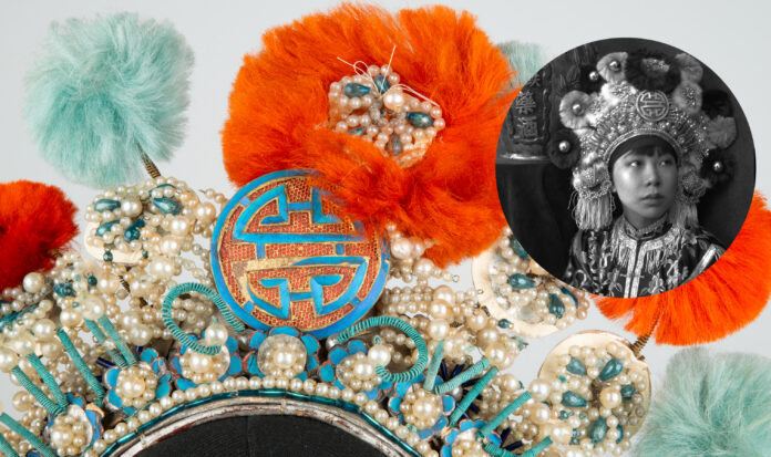 Person with elaborate headpiece on looking up and the their left.