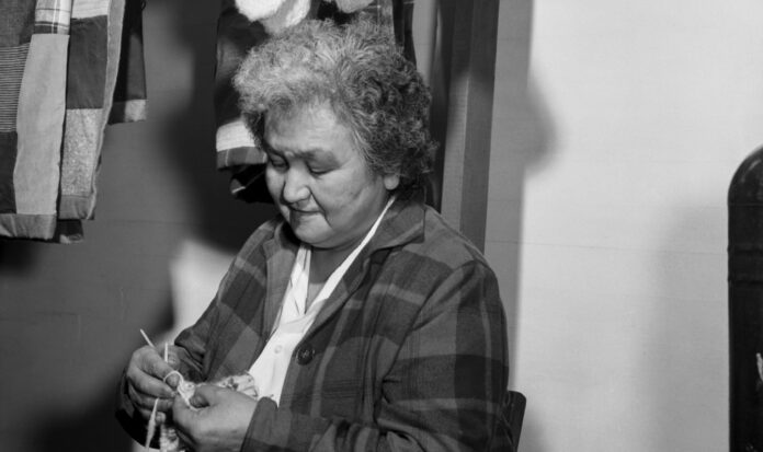 Lillian Jones knitting socks at thrift store