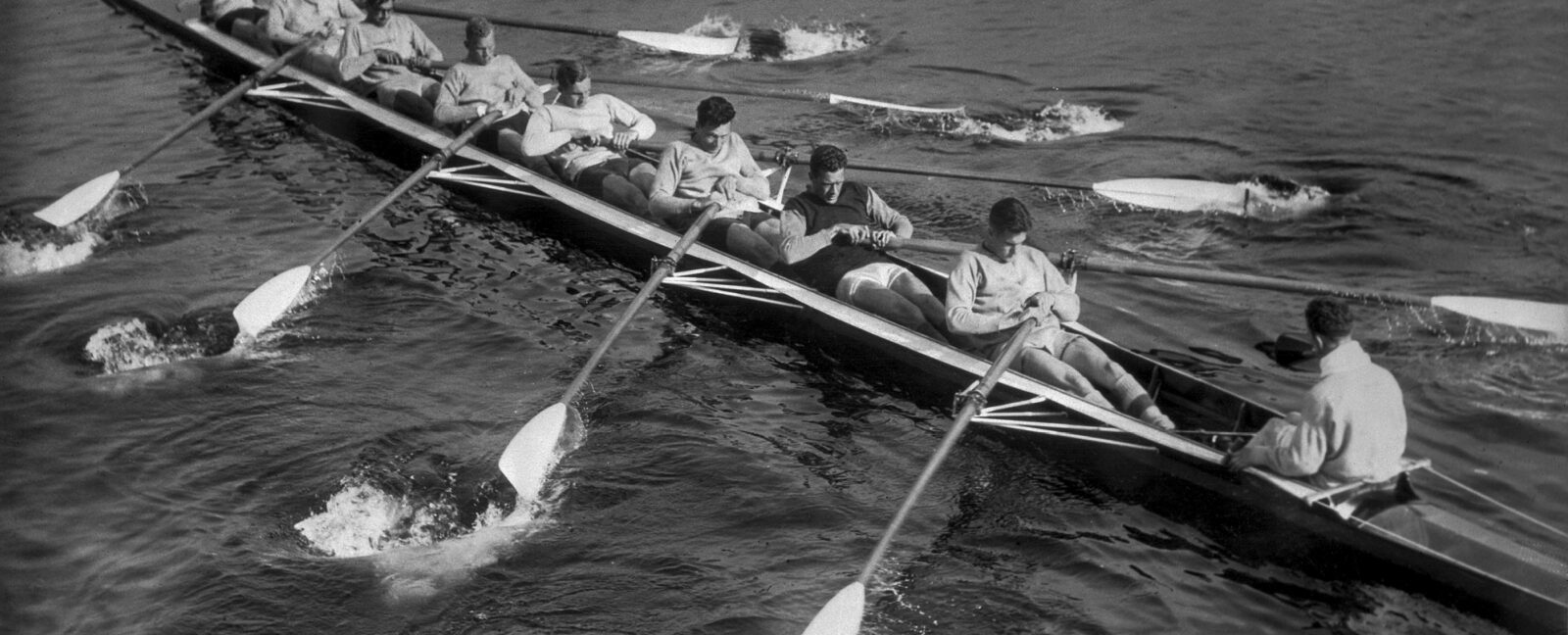 Mens rowing team on the water.