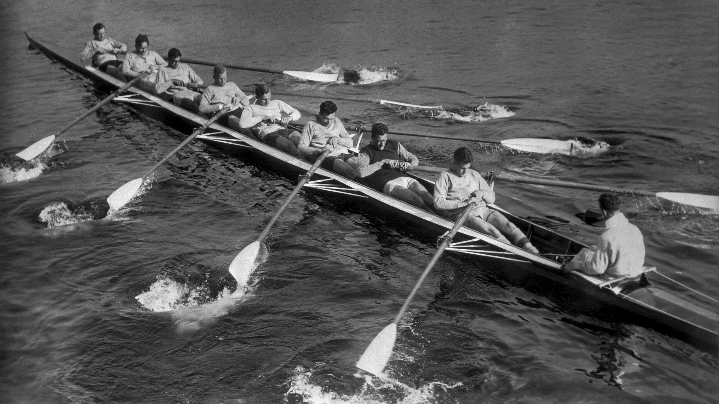 Mens rowing team on the water.