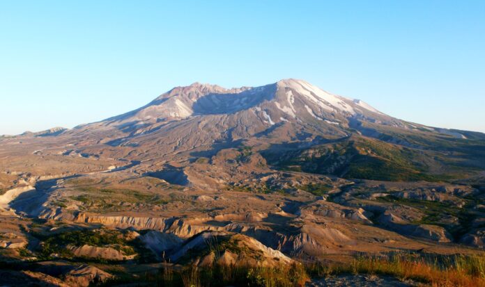 View of mountain with scooped out peak set against clear blue sky.