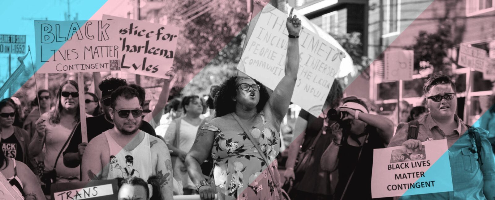 Group of people marching with Black Lives Matter and Trans Pride signs.