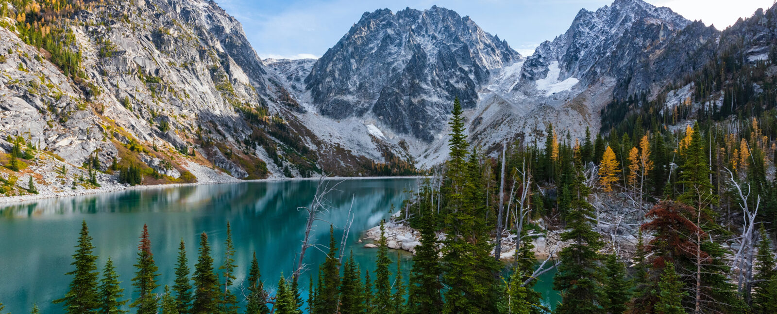 A blue lake surrounded by lush green grass