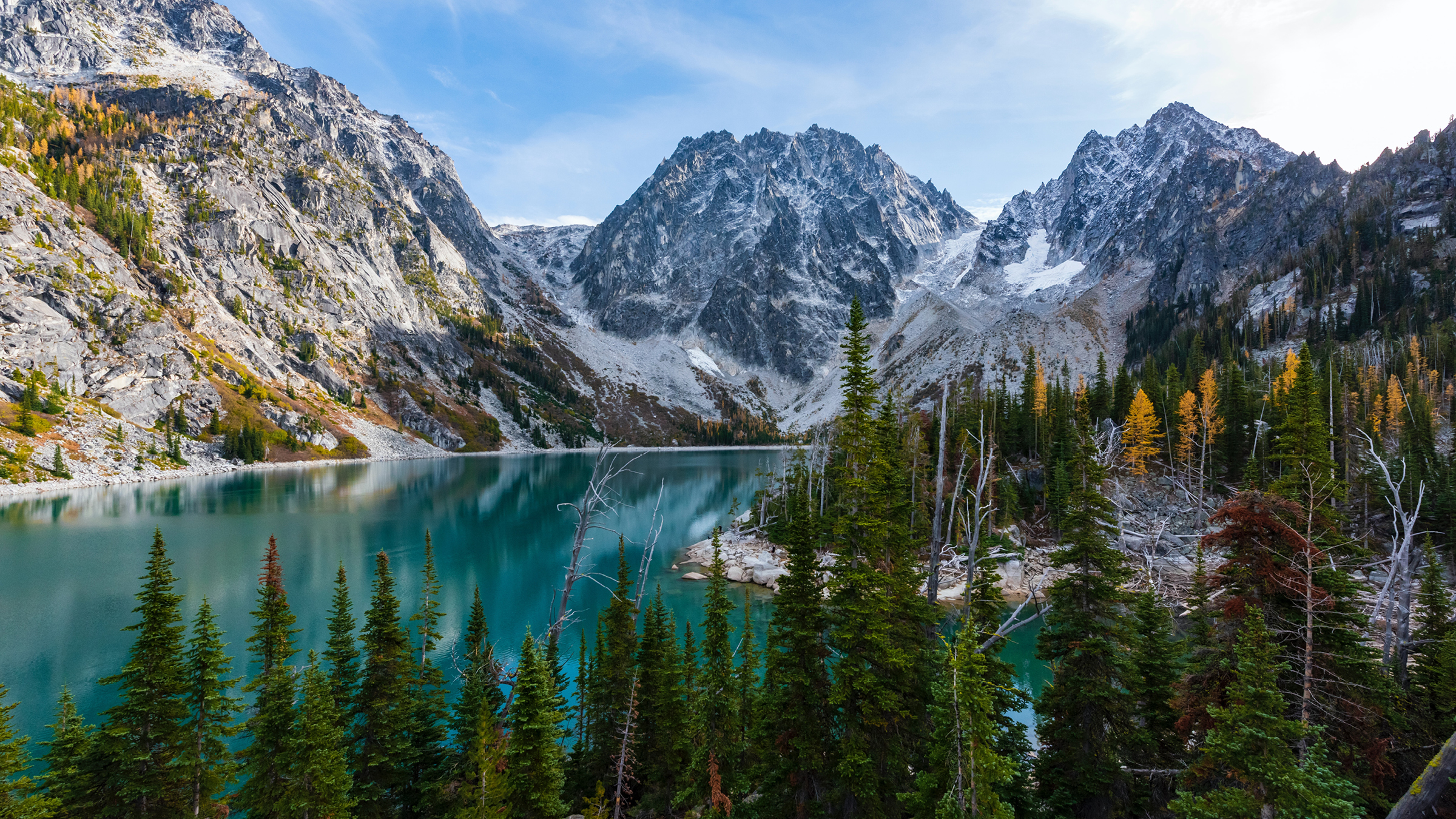 A blue lake surrounded by lush green grass