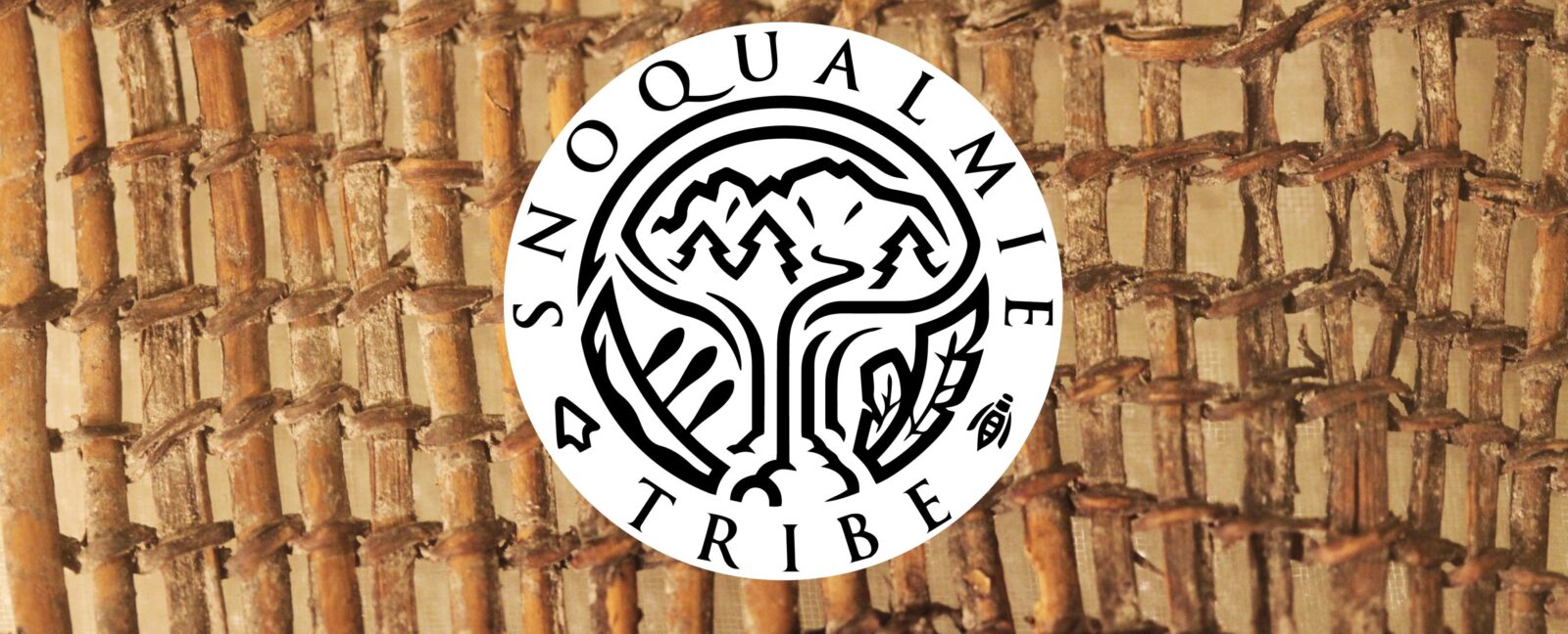 Snoqualmie Tribe logo over a woven bamboo mat.