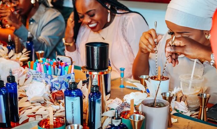 Smiling people making candles.