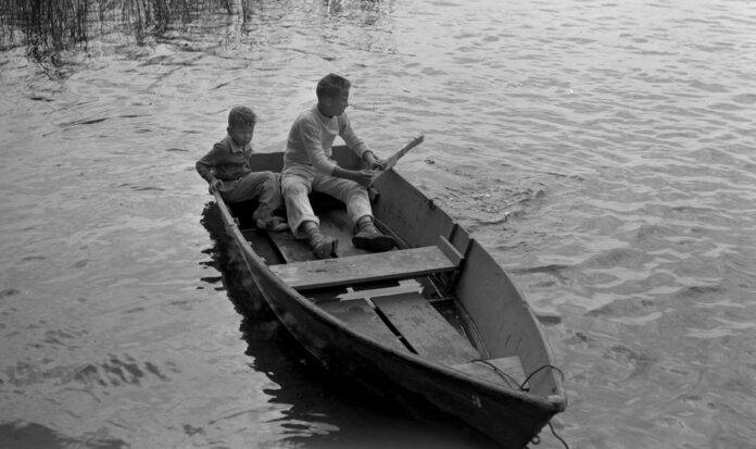 Butch Smith and Sonny Norris sitting in rowboat
