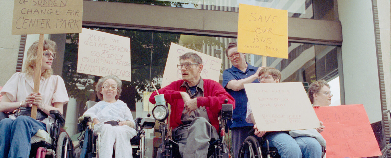 A group of individuals in wheelchairs protesting in support of disability rights in Seattle