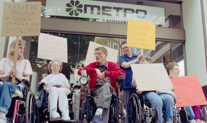A group of individuals in wheelchairs protesting in support of disability rights in Seattle