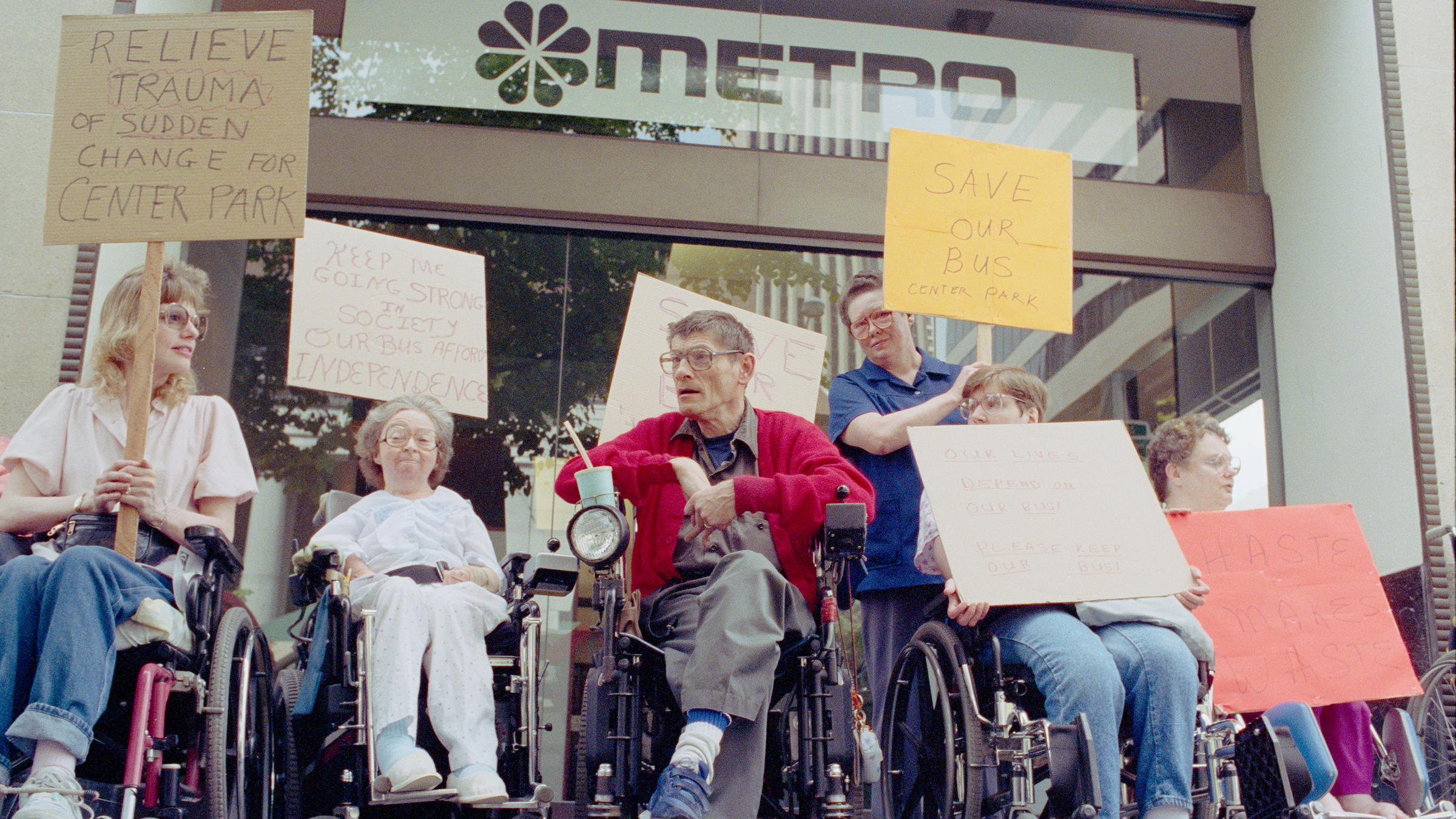 A group of individuals in wheelchairs protesting in support of disability rights in Seattle
