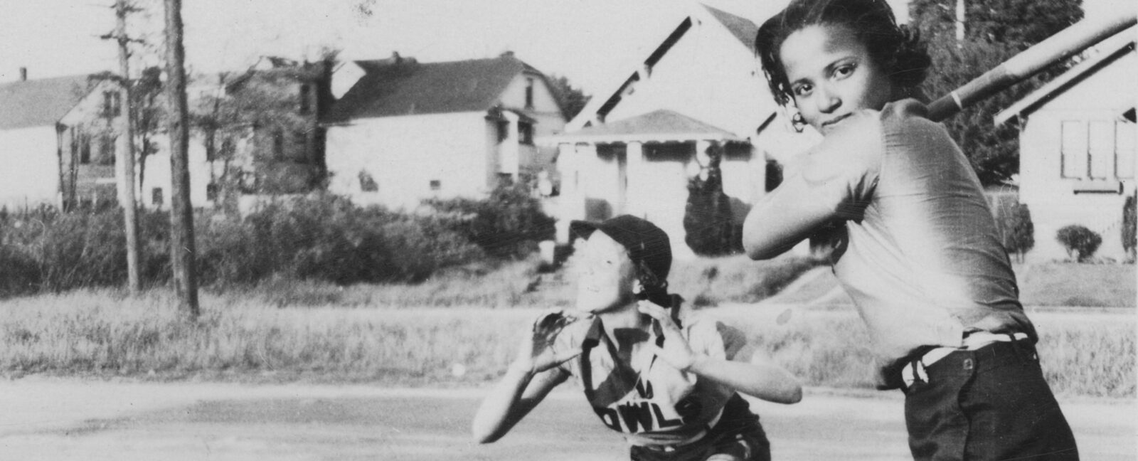 Black and white photo of two Owls Club softball players circa 1938. One is catching