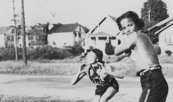Black and white photo of two Owls Club softball players circa 1938. One is catching