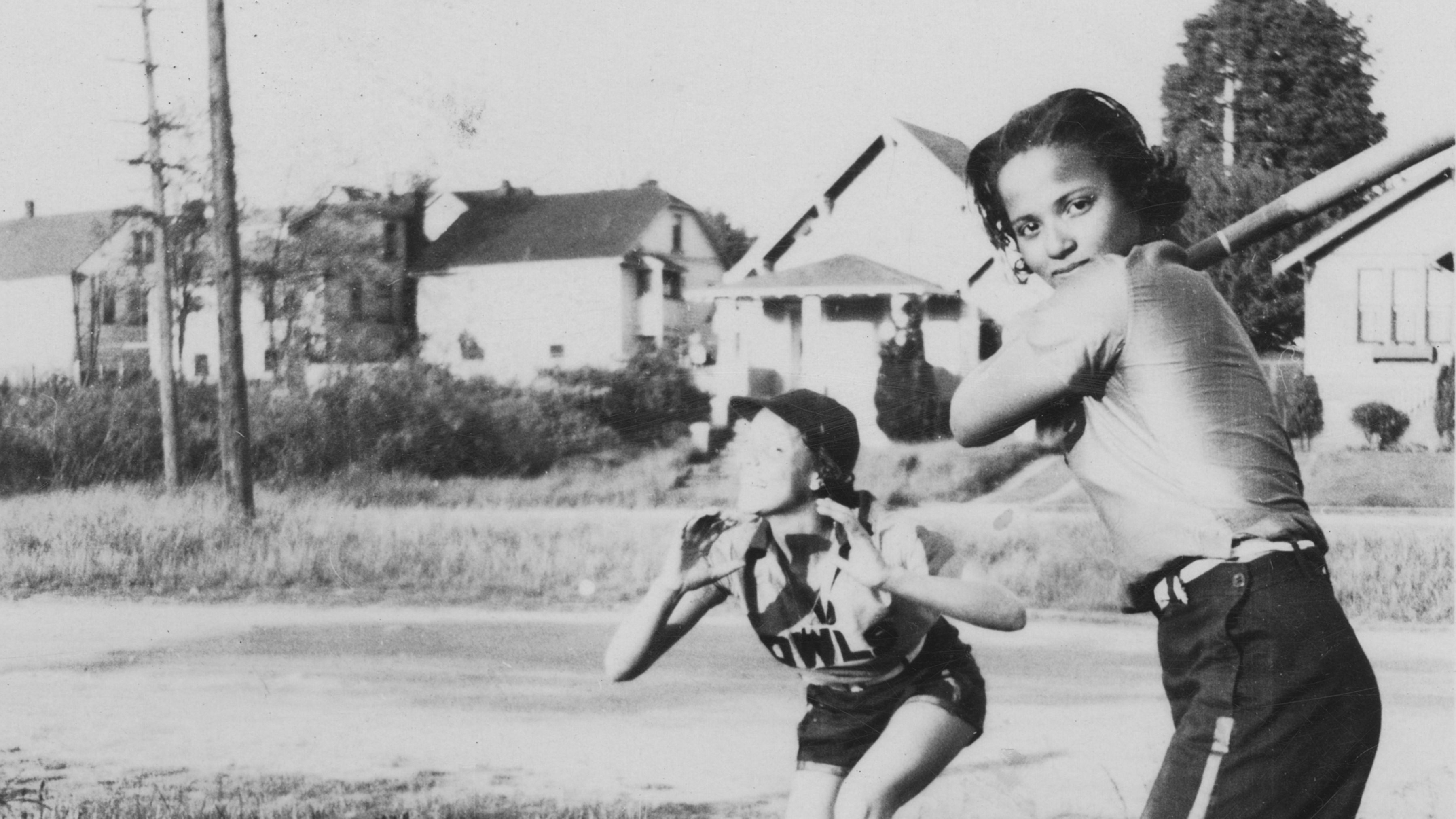 Black and white photo of two Owls Club softball players circa 1938. One is catching