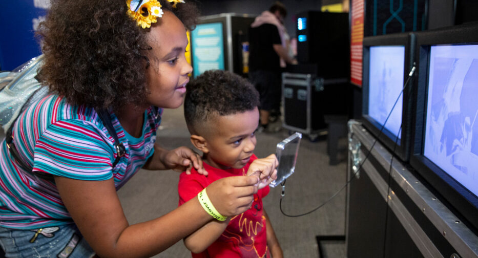 Boy and girl engaging with artificial intelligence activity.