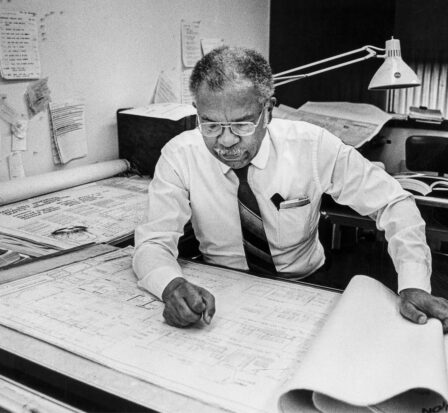 Benjamin F. McAdoo Jr., architect, at work at drafting table.