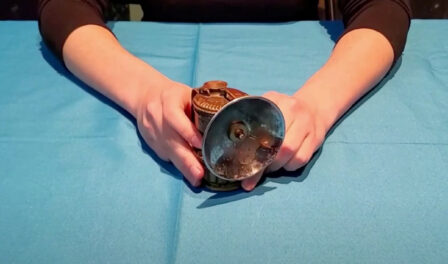 A coal miner's lamp on a blue table.