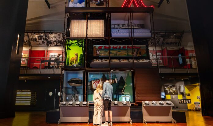 A couple explores an interactive exhibit in the Grand Atrium at MOHAI.