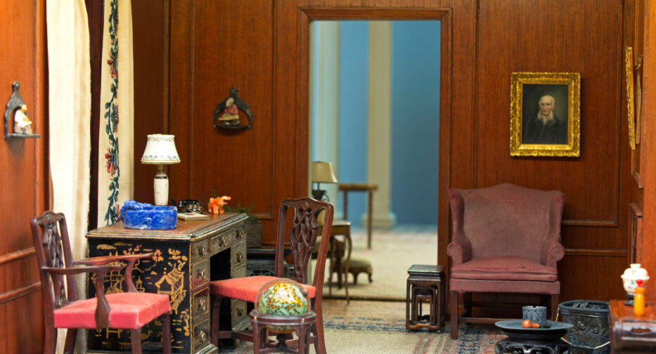 The interior of the Hammons House office with desk, chairs, and a window with full length curtains.