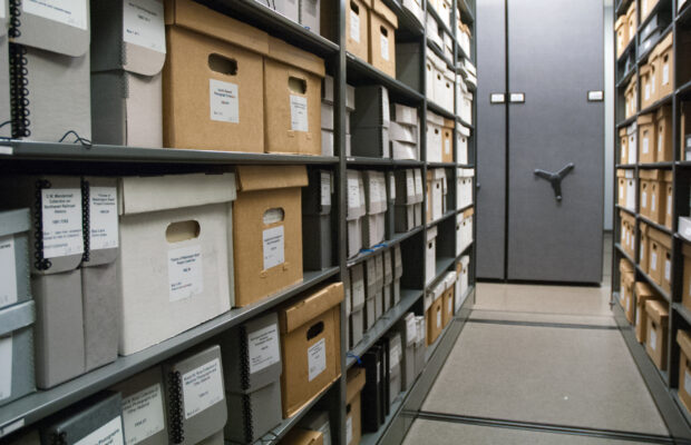 Archives collections in various cardboard boxes in MOHAI storage.