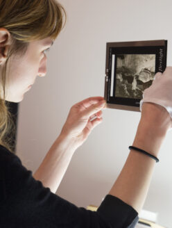 MOHAI employee preparing a photo negative for scanning.