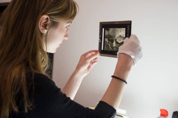 MOHAI employee preparing a photo negative for scanning.