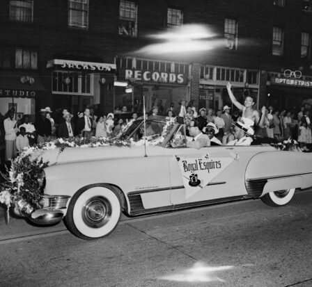 Festival queen waving from car during parade, Seattle, circa 1950.
