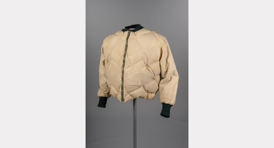 A cream colored Eddie Bauer jacket with a black color and cuffs.