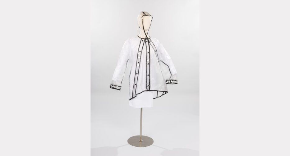 A Colette raincoat (Clear Coated, 2018) featuring sets of snaps, arranged in a triangle, to allow for a narrower or wider fit. The cuffs can be wide or snap closely to the wrist.