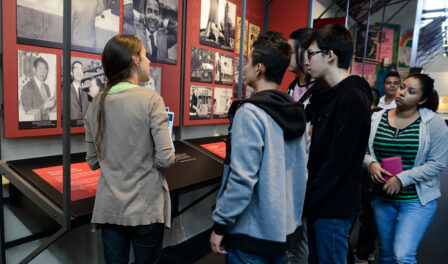 Students looking at photos during a self guided school year exploration field trip at MOHAI.