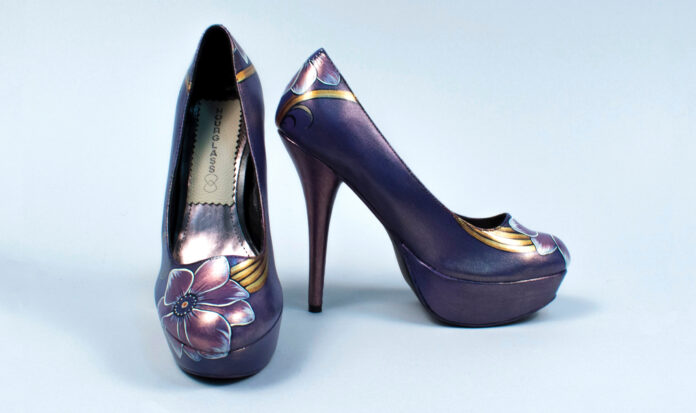 Purple high heel shoes with a flower painted on the toe.