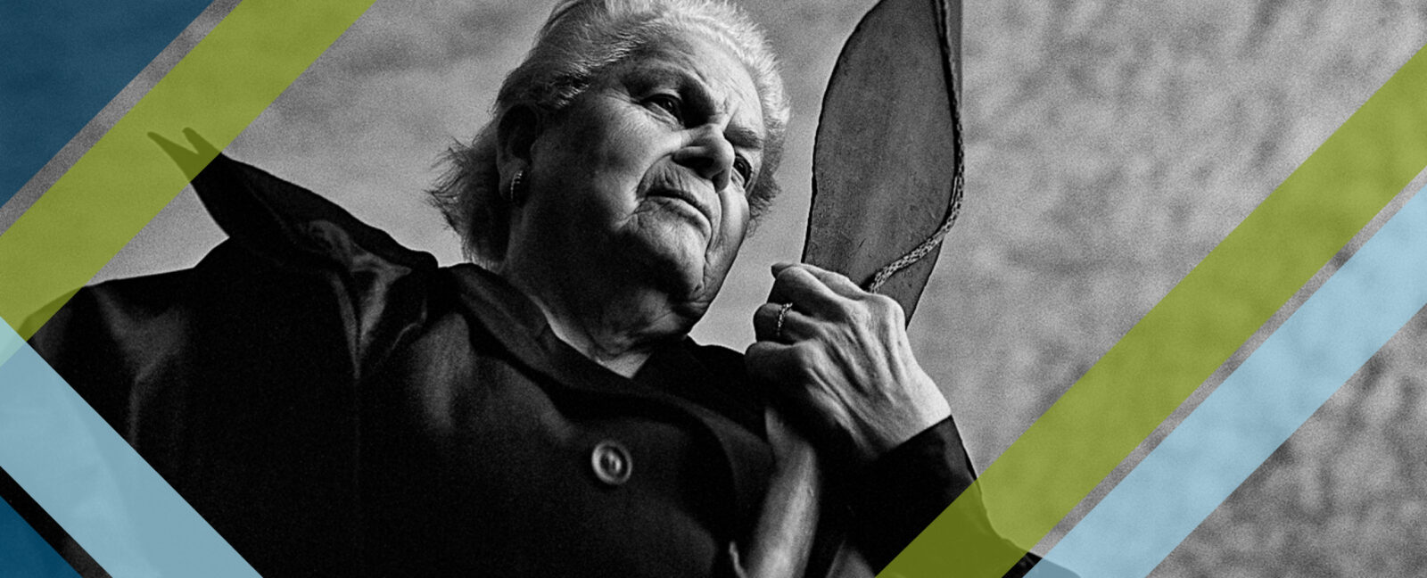 Ann Rasmussen gazing into the distance while holding a canoe paddle.