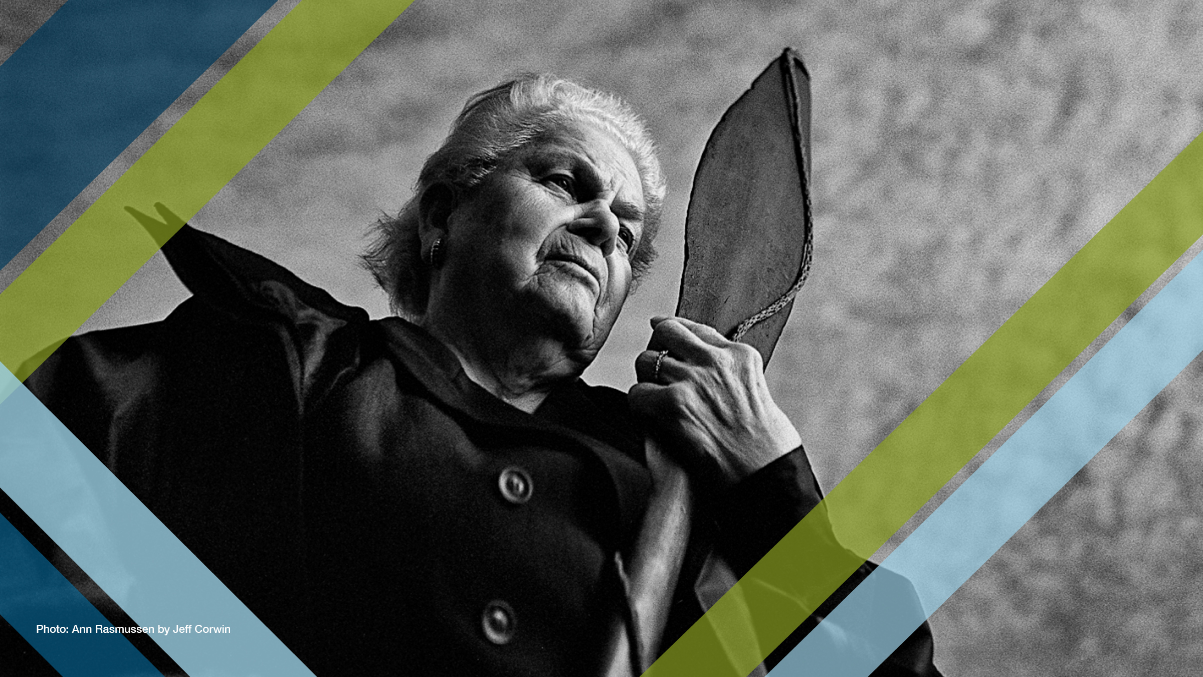 Ann Rasmussen gazing into the distance while holding a canoe paddle.
