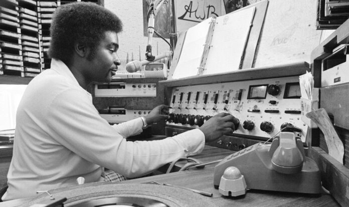 Robert L. Scott in booth at KYAC radio station
