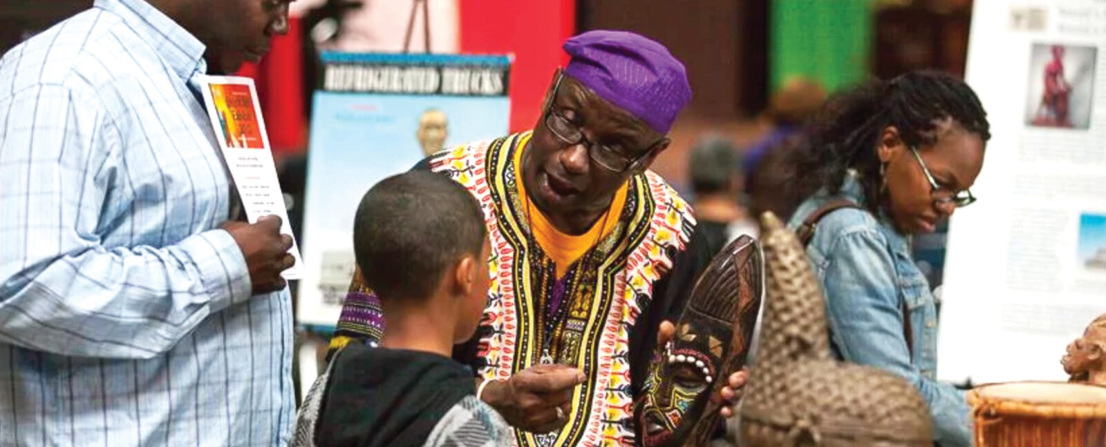 Delbert Richardson speaking with a young child.
