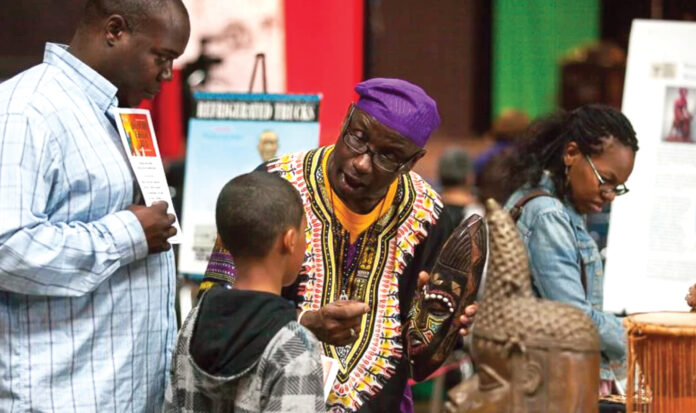 Delbert Richardson speaking with a young child.