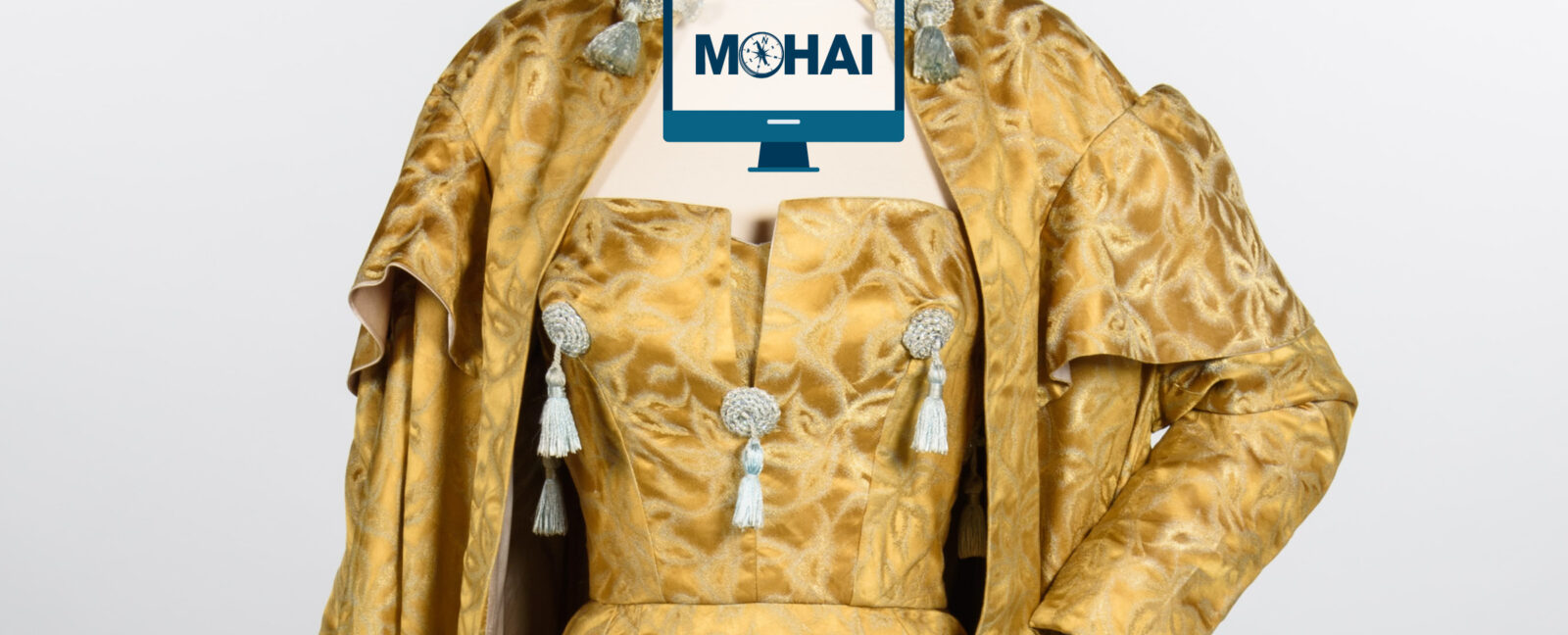 A gold colored outfit with grey tassles.