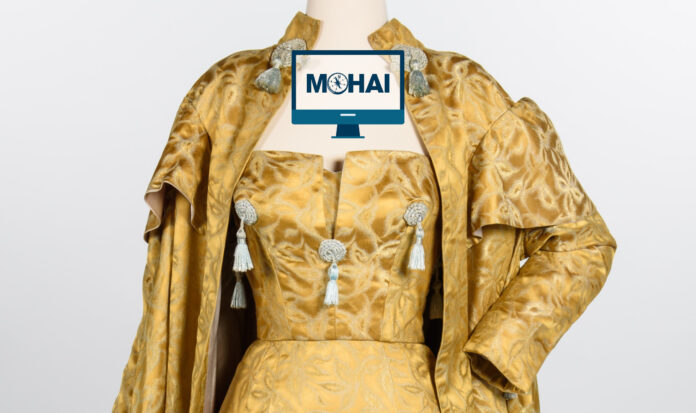 A gold colored outfit with grey tassles.