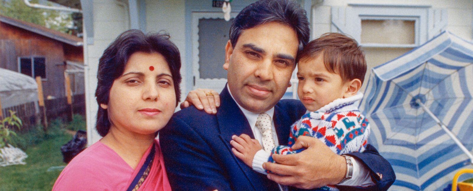 Harish Bharti and family in front of their home