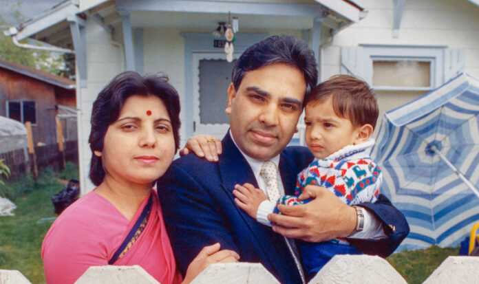 Harish Bharti and family in front of their home